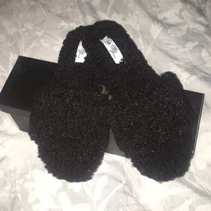 Fluffy black slippers.